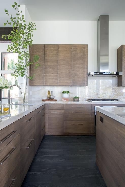 Dark wood cabinets in a white marble kitchen